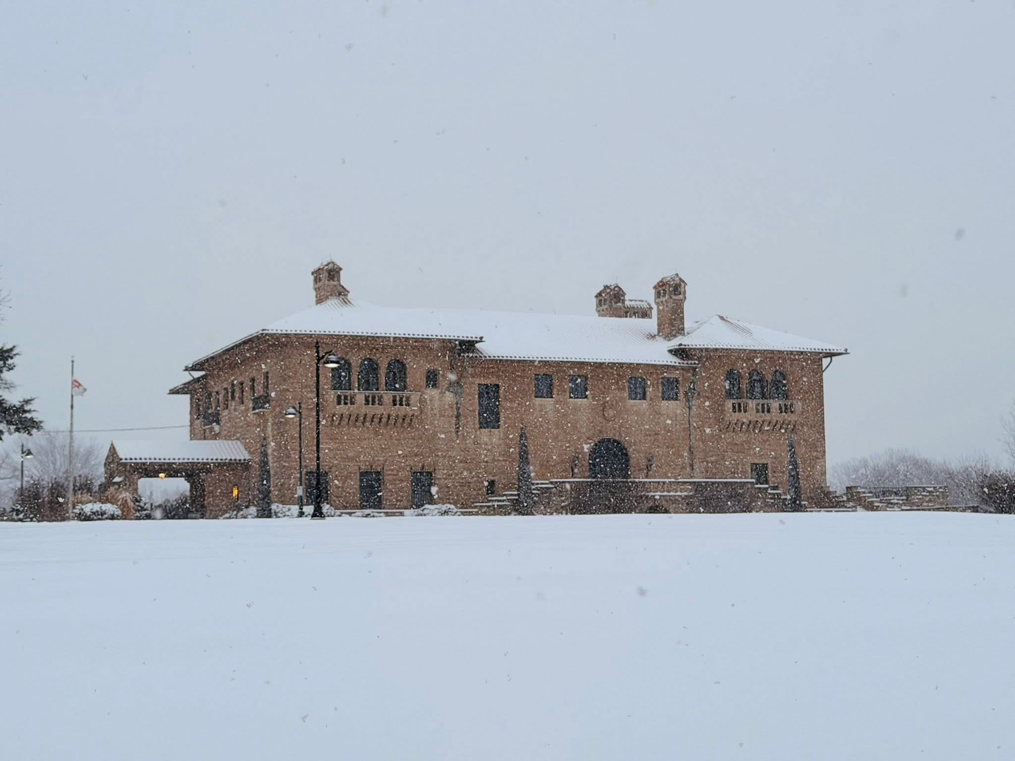 The Marland Mansion in falling snow during the Festival of Angels season